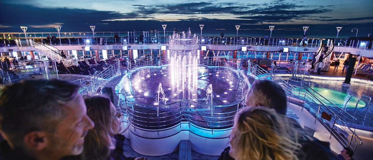 A glittering water show on the pool deck choreographed with colors and music
